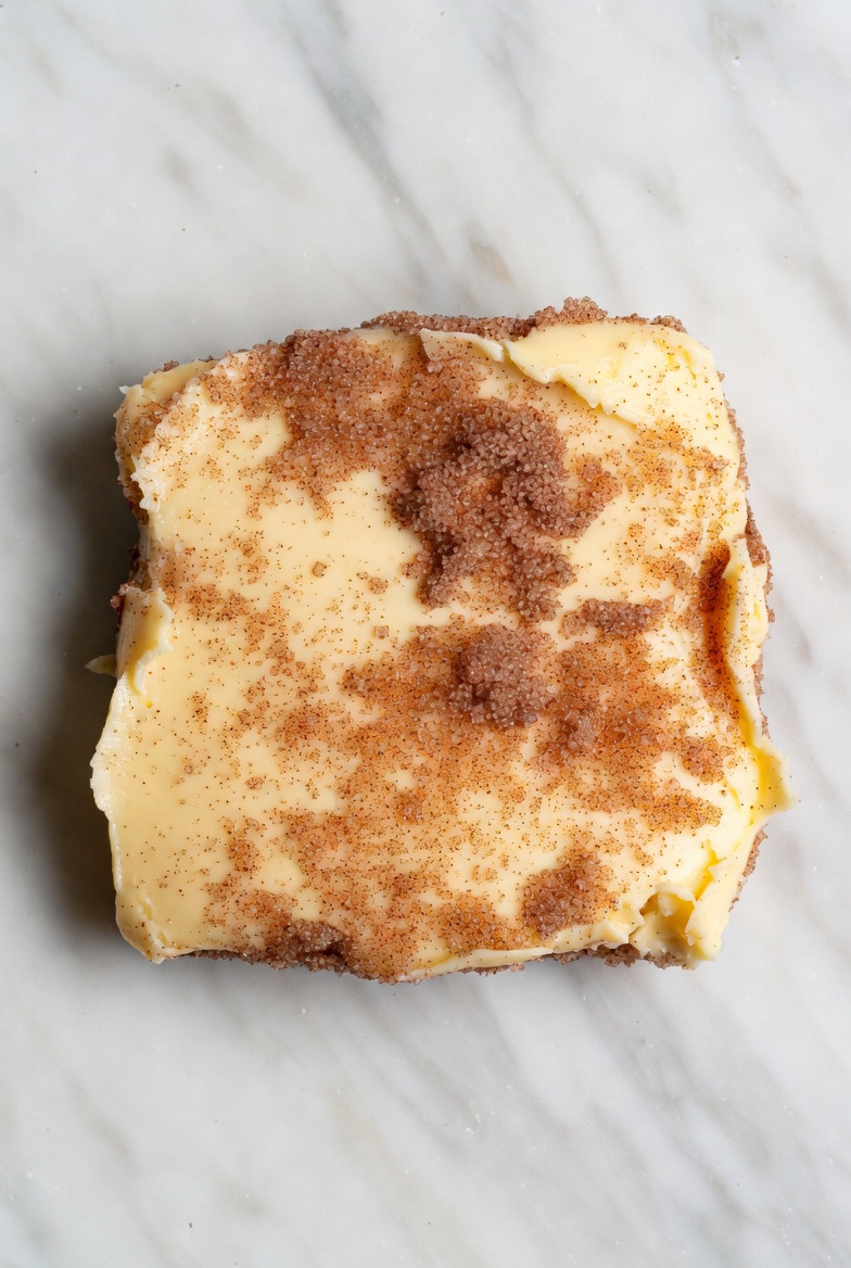 Cinnamon Sugar Square Butter Blanket with brown sugar crystals on marble